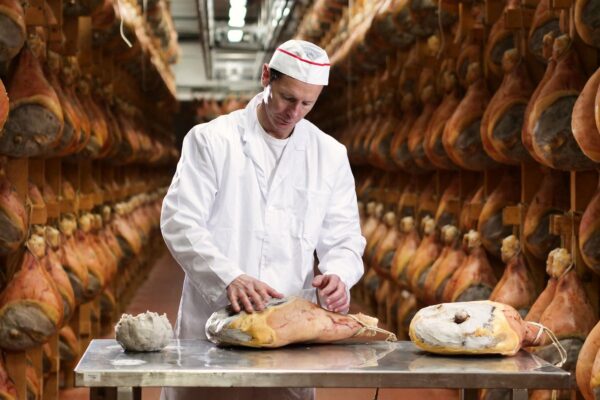 Close Up Of A Hand That Gathers The Ham With Fat Before It — Culinary tour of Italy by Italy Travel Specialist