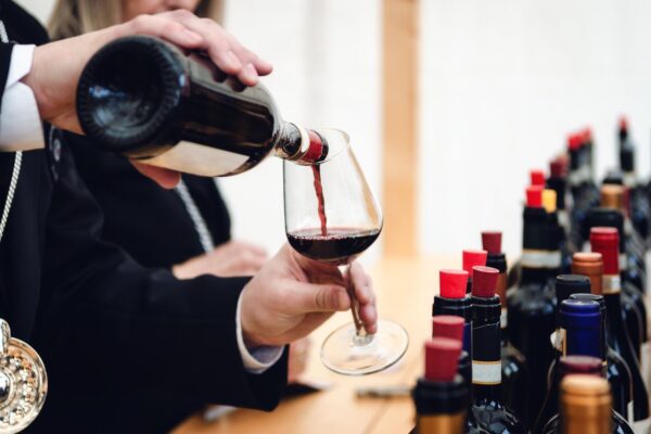 Tasting Experience With A Male Sommelier Serving A Glass Of — Langhe and Sardinia tour by Italy Travel Specialist