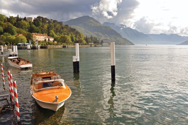 View Of Lake Como In A Cloudy Day With Motorboat And Harbor — Northern Italy luxury tour by Italy Travel Specialist